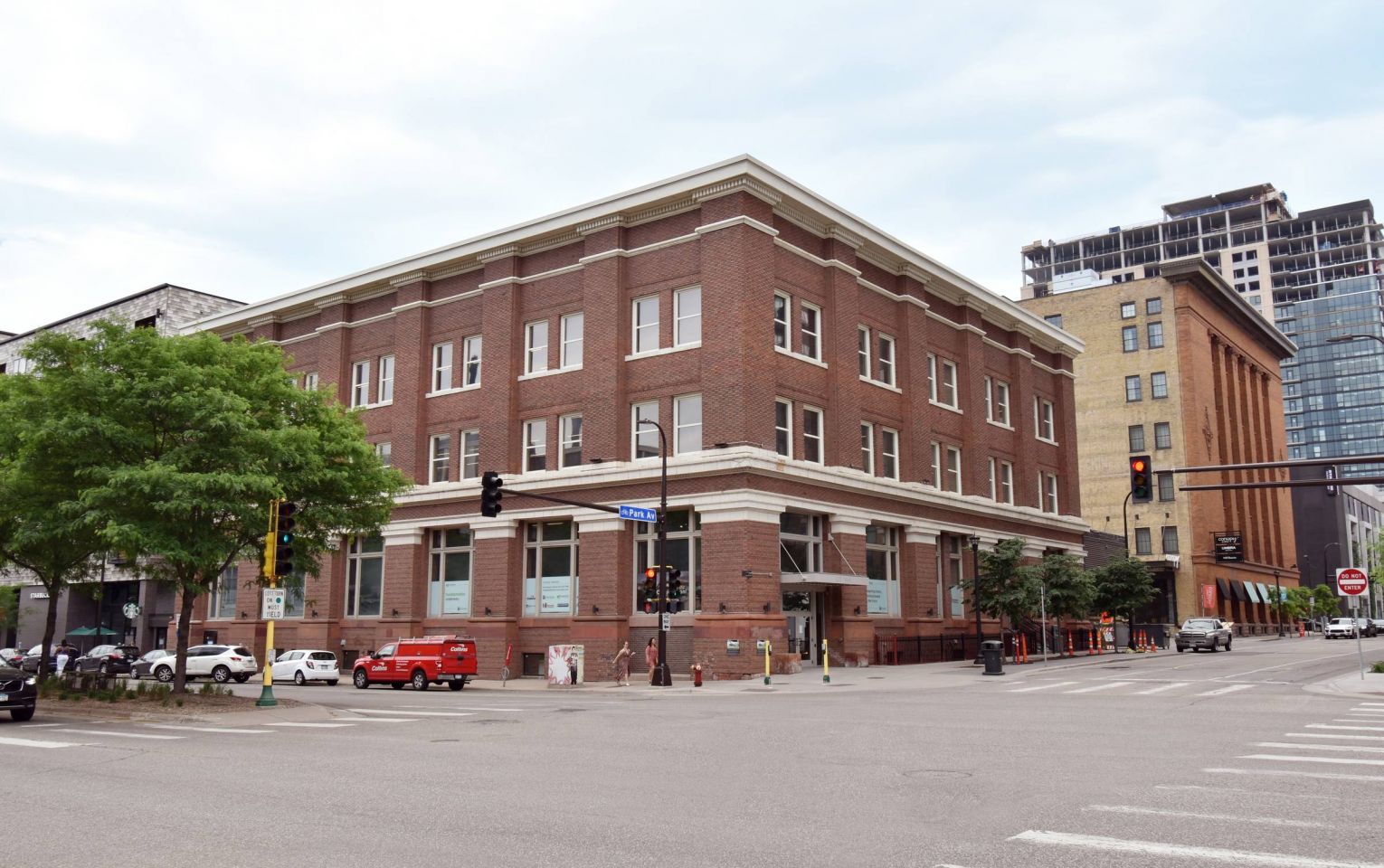 The exterior of the JI Case building at a street corner, showcasing its classic brick architecture and large windows.